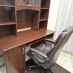 Office desk, big office chair and mahogany bamboo roll up chair mat 