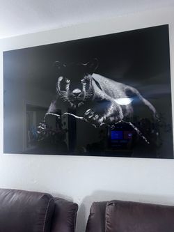 Glass-framed print of a black panther