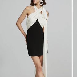 HALSTON mini dress features a bow and tie detailed design, adding glamour to its two-tone construction. It has a hidden back-zip closure and a sl