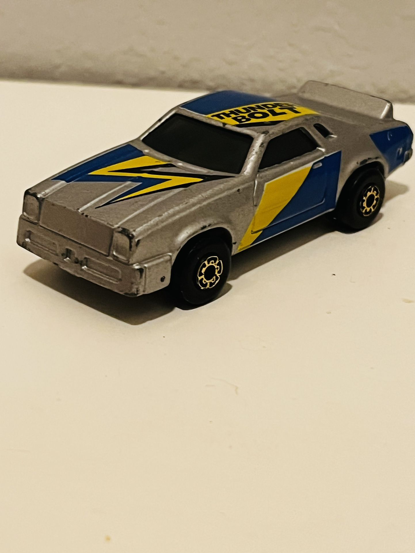 Matchbox 1983 Mega Blasters Cap Car Thunder Bolt Silver/Blue/Yellow