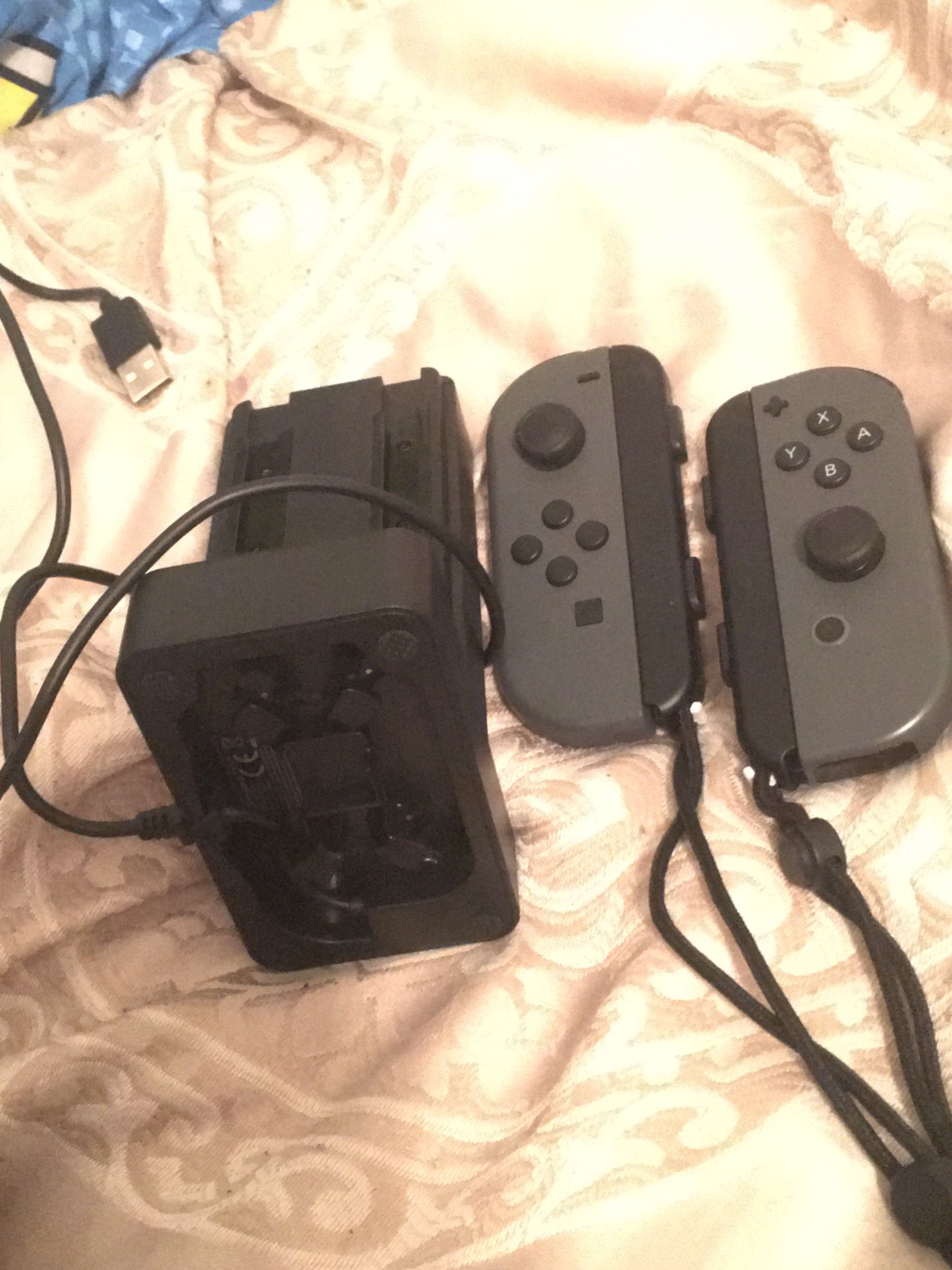 Grey Nintendo Switch joycons with four way controller charge dock