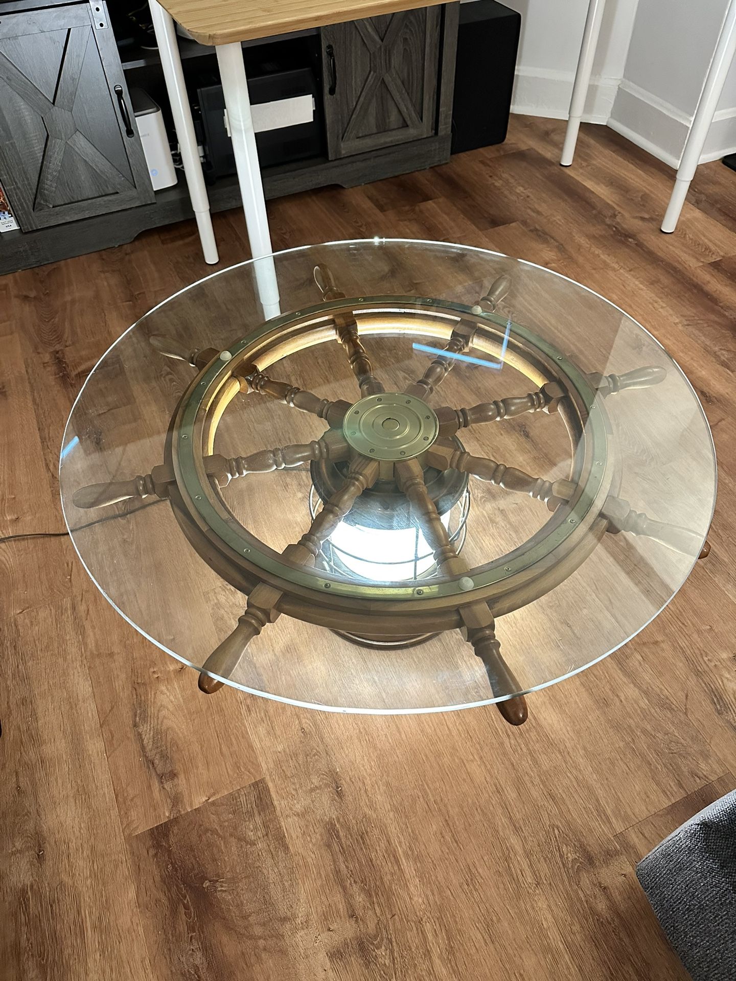 Round glass top nautical lantern/ship's wheel base cocktail table - no contents 36x36x17