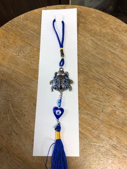 Blues evil eyes charm with a ladybug
