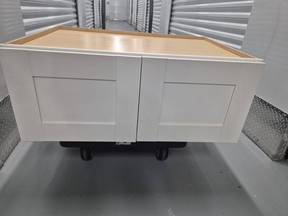 A cabinet placed on top of a refrigerator, especially when part of a cohesive kitchen