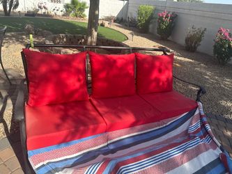 Metal couch with red cushions