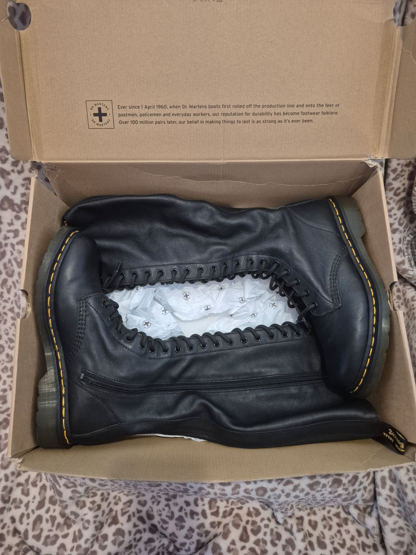 Dr. Martens 1B60 20-Eye Virginia Leather Knee High Boots in black.