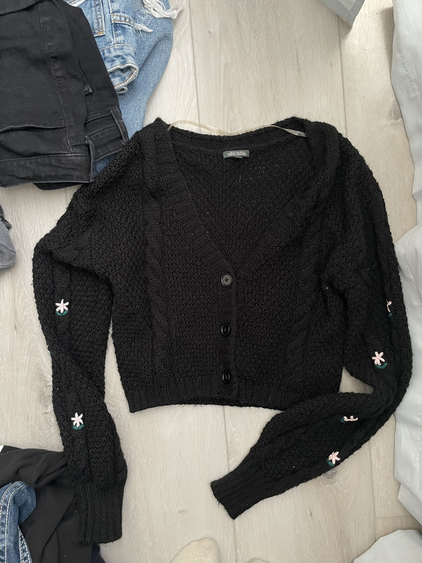 black cardigan with little flower pattern on the arms