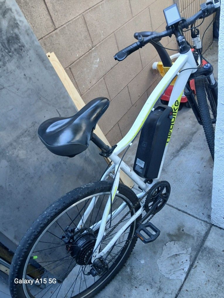 White electric bicycle comes with its charger in good condition