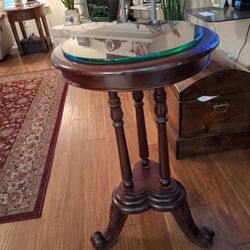 3.5 Tall Antique dark wood pedestal table with turned legs and a glass top