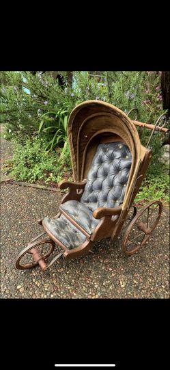 Antique Leather Baby Carriage This shows lots of wear Size 22” tall x 14” wide x 22 1/2” long Metals wheels with wood and leather cover. One brace f