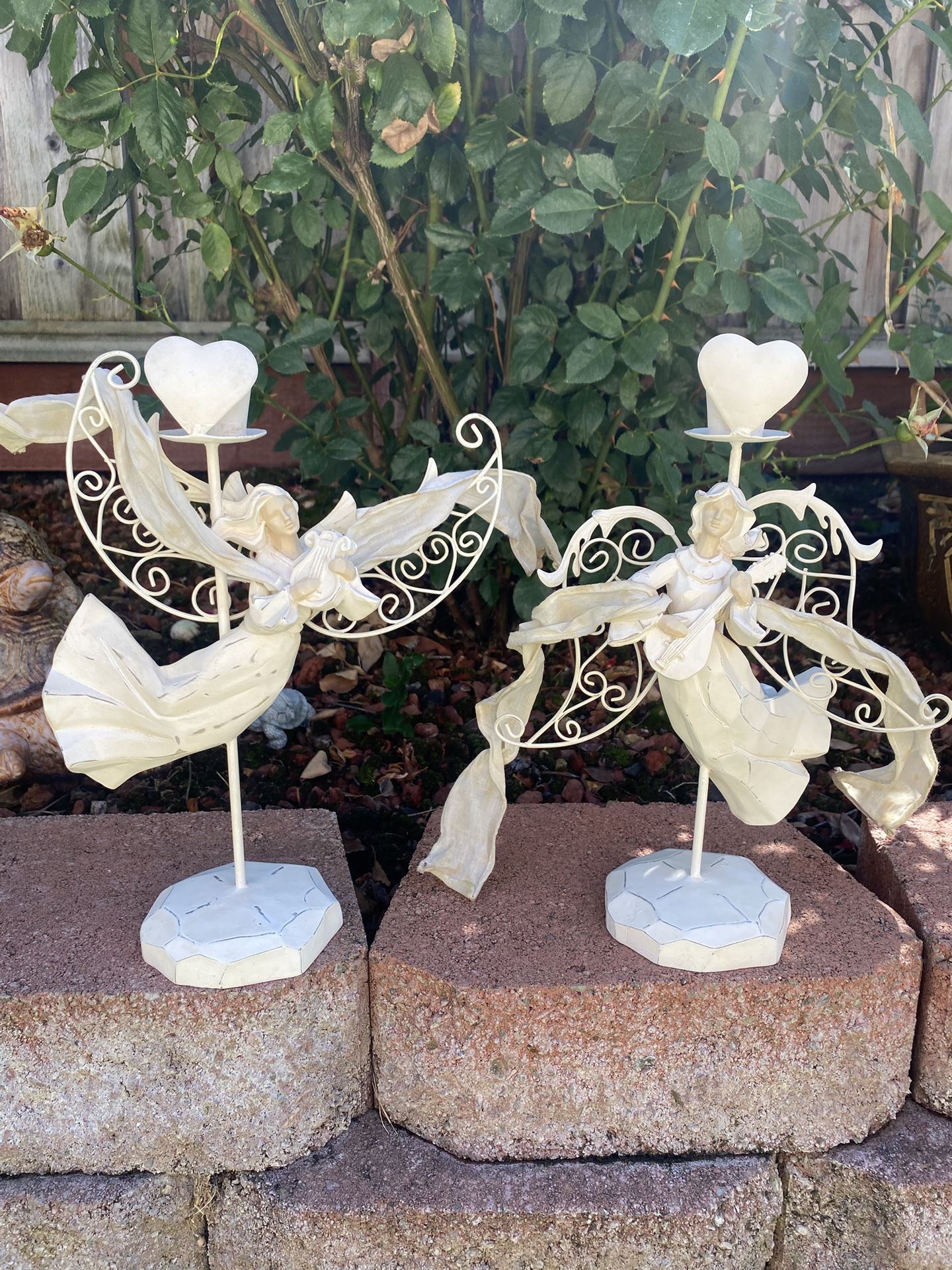Two white metal angel candle holders