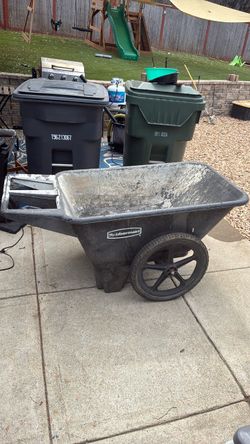 Grey Rubbermaid wheel barrel