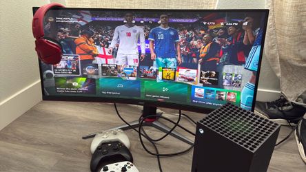 Xbox with monitor and 3 controllers