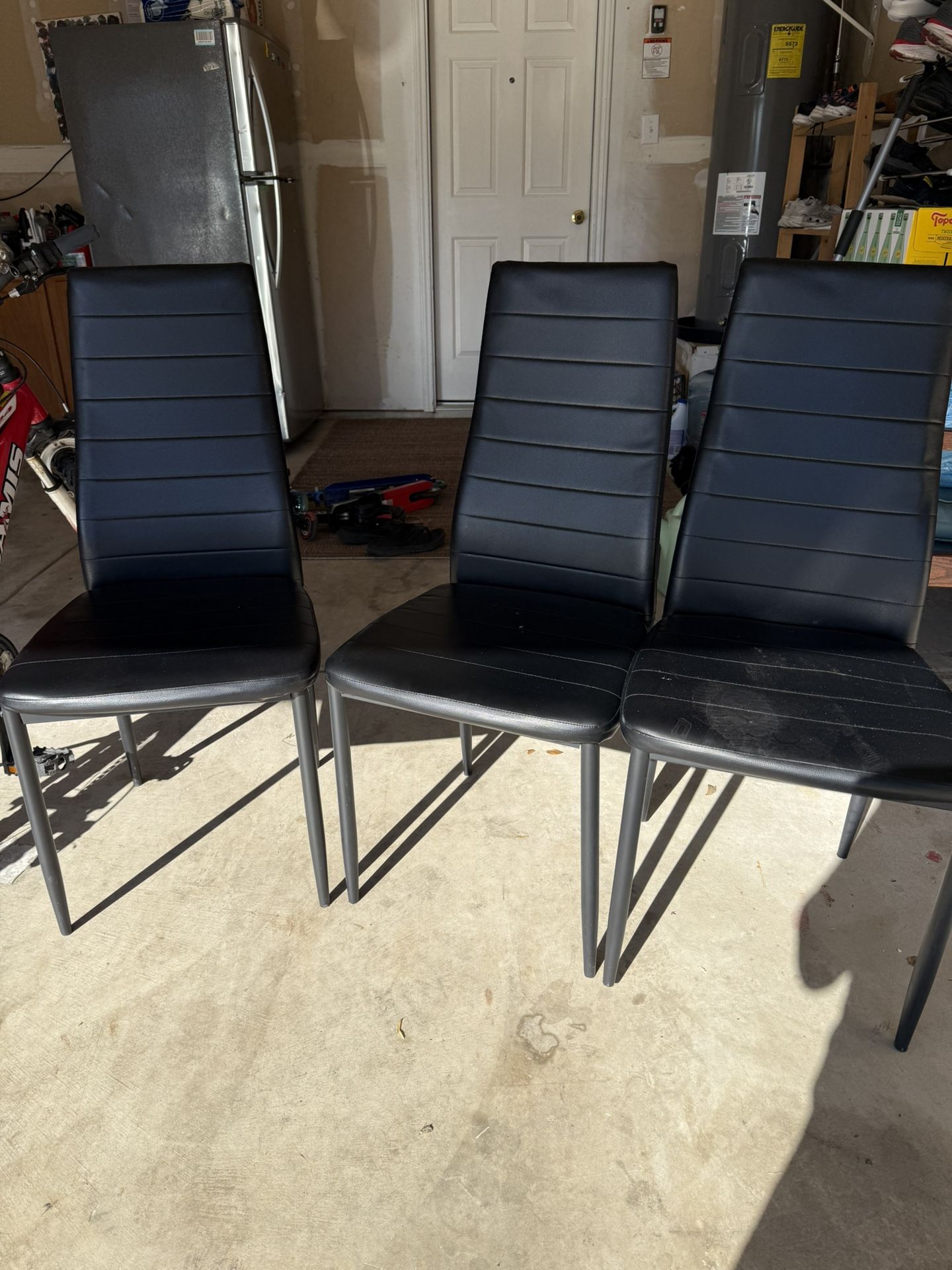 Three black leather chairs, like new.