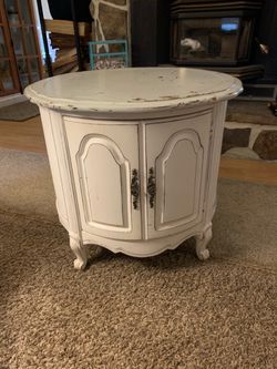 vintage French Provincial round drum cabinet with distressed white finish and ornate Hardware