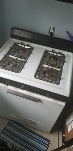 Full sectional couch with 2 foot rests, fridge, and stove