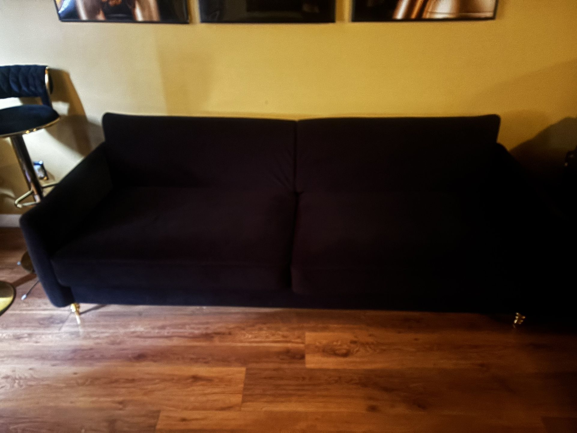 Black Sofa With Gold Swirled Legs 