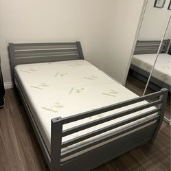 Sturdy gray bed frame with a nice Bamboo mattress. Frame has a slatted headboard and footboard. Mattress is clean. Good for a spare room or kid's room
