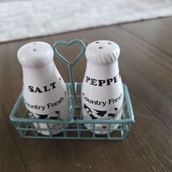 Vintage ceramic "Country Fresh" milk bottle salt and pepper shakers in a blue wire heart-shaped carrier