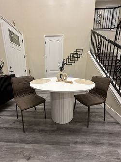 Beautiful custom handmade round dining table with a modern pedestal base. Clean, neutral design
