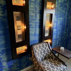 pair of decorative wood wall art panels featuring abstract, textured inserts.