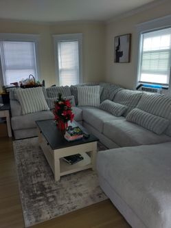Large grey couch  with pillows. Velvety soft.