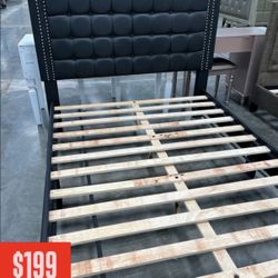 ✨ Modern Black Upholstered Bed Frame – $199 ✨  Upgrade your bedroom with this stylish and sturdy black upholstered bed frame. The tall padded headboar