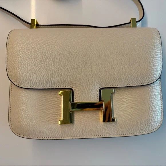 Cream color H Constance crossbody bag with gold hardware.