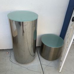 polished aluminum or chrome drum side table with a glass top, 