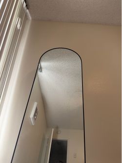 Black arched mirror with thin frame #arched #minimalist  Size: 64"L x 21"W | Color: Black-rounded