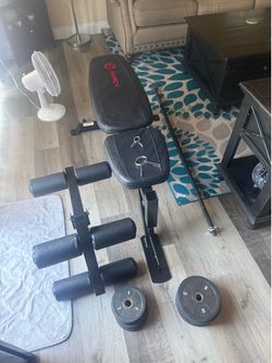 Workout bench w/ leg extension + barbell & weights
