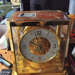 Jaeger‑LeCoultre Atmos Clock – Brass & Glass – Swiss Made”.