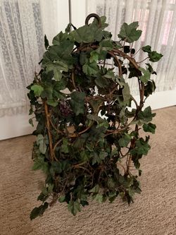 Artificial Grape Vine on a metal wine bottle holder
