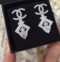 Chanel shield pin crystal rhinestone silver badge brooch CC logo+ a gift of Chanel  Earrings for Sale in Fremont, CA - OfferUp