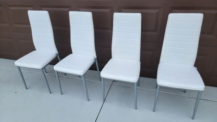 Set of 4 modern, high-back white faux leather dining chairs with padded seats and slender metal legs.
Seat high is 18 inch.
The price is for 3 chairs,