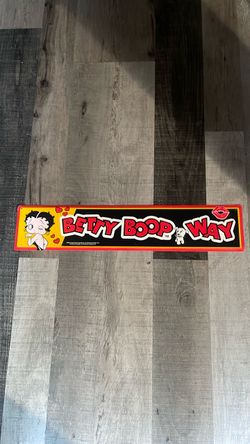 This is a vintage Betty Boop Way metal tin sign released