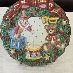 Fitz & Floyd ceramic Christmas wreath plate with toys. 8.25”