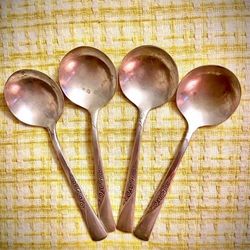 1953 Revelation Bouillon Spoons featuring a floral design on the handle.m