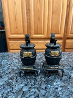 Vintage Plastic Pot Belly Stove Pair of Salt and Pepper Shakers.  Size approximately 4 inches tall.  Preowned never used.  Has been on display in a ca