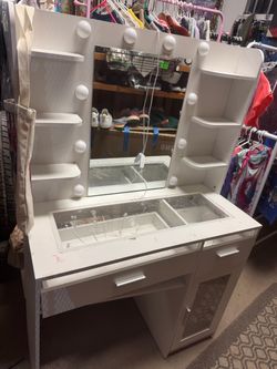 Vanity white mirror lights meed a wire to be fixed got ripped in move drawers needs TLC been in storage needs a good cleaning and paint .