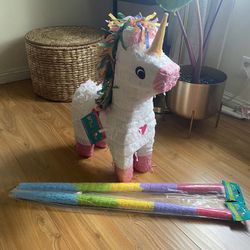 Unicorn Piñata And Colorful Batting Sticks