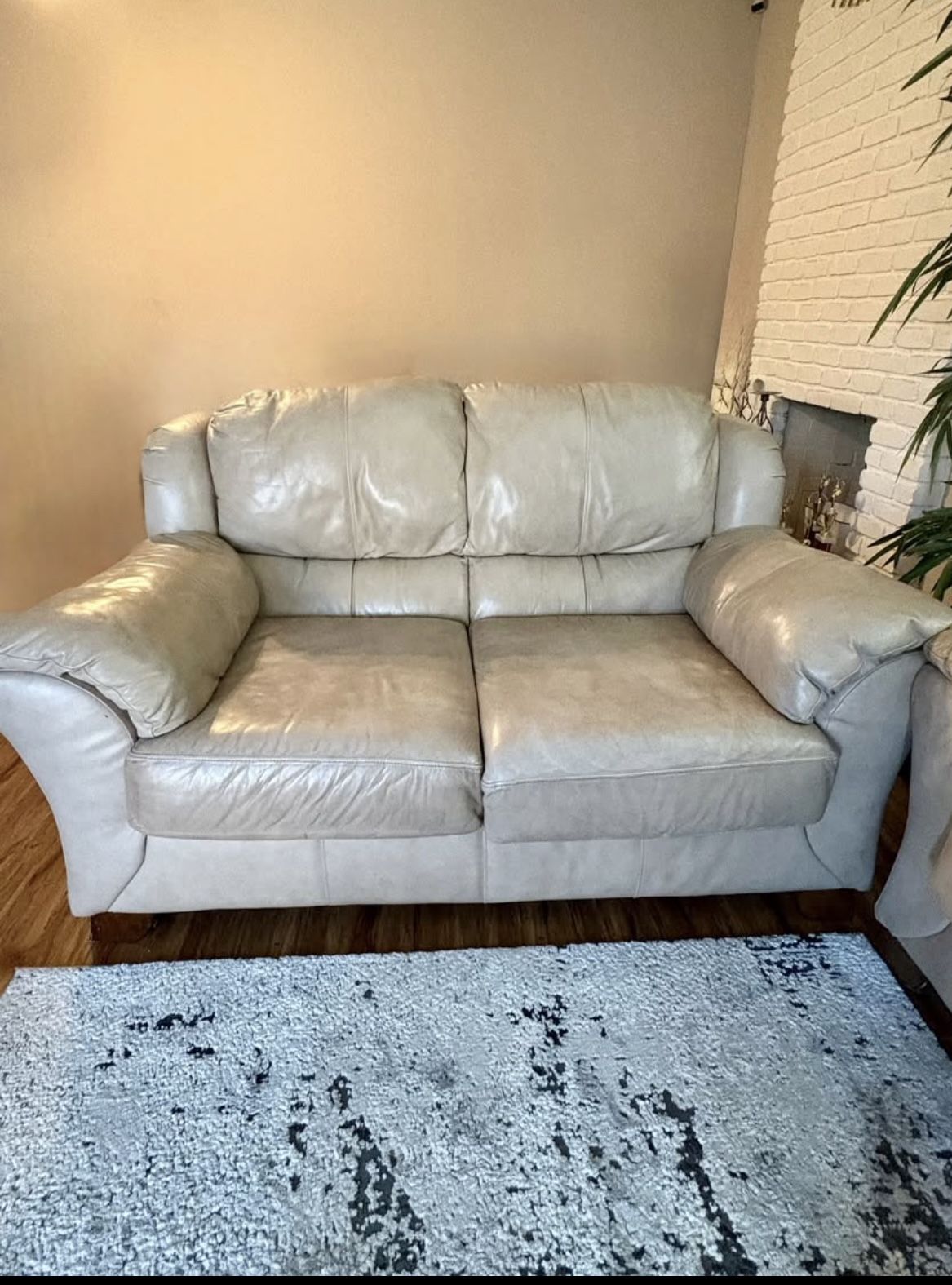Beige leather loveseat