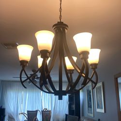 A Beautiful Black Chandelier with Frosted Glass