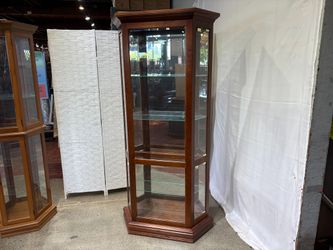 RIVERSIDE FURNITURE 35″ Wide Illuminated Trapezoid Shaped Curio Cabinet