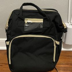 Diaper bag with changing station