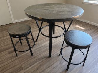 Dining table and swivel stools