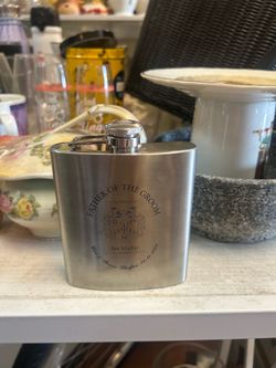 tainless steel hip flask is engraved with "Father of the Groom,"