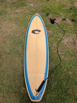 7 foot WRV surfboard built by Tommy Moore with leash in excellent condition. Has three fins and ready to surf today. Signed and numbered by the maker 