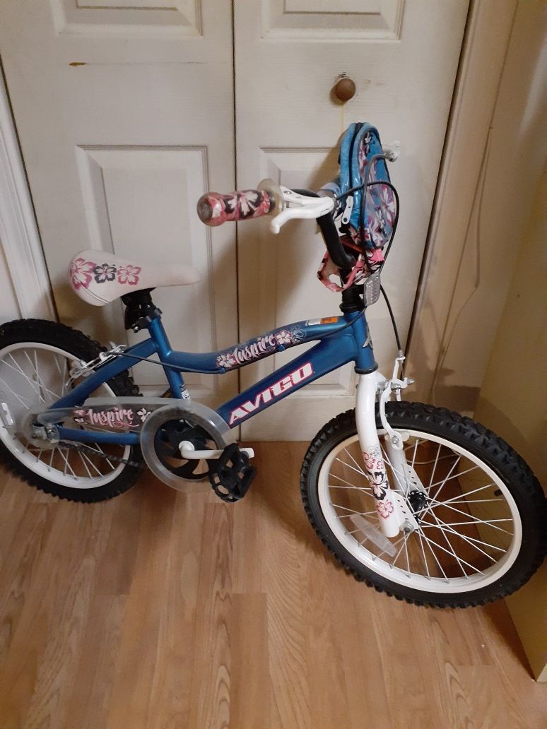 Blue girls bicycle with Hello Kitty safety gear