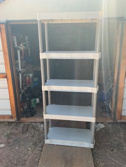 -Tier Plastic Shelving Unit it’s 74 inches tall 30 inches wide and 14 inches deep